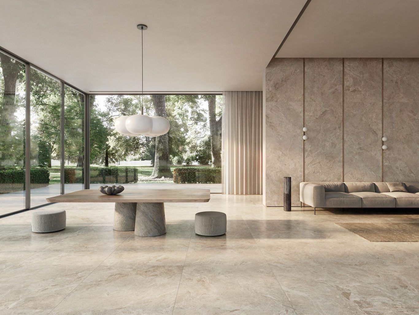 Catálogo 2026 Sala moderna con paredes de piedra, mesa de piedra y sofá, rodeada de grandes ventanales.